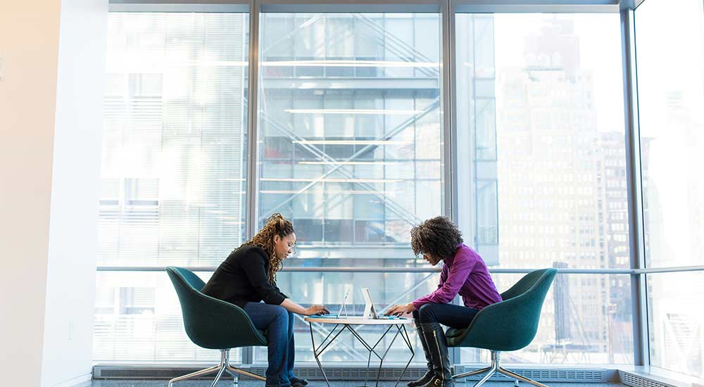 An agent sitting at a coffee table with a client