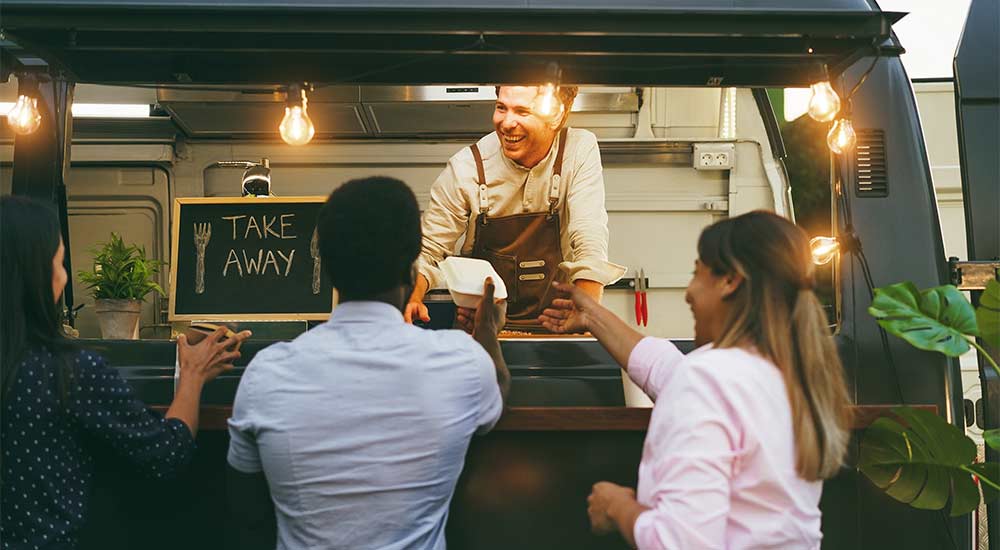 A couple ordering food at a food truck